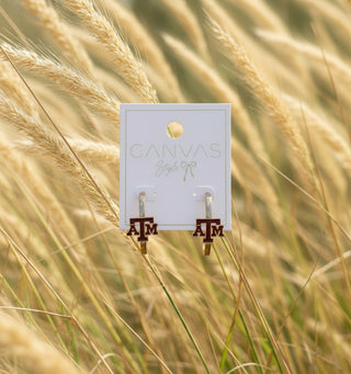 Officially licensed A&M hoop earrings with worn gold plating and maroon enamel detailing, 1.5-inch post-back hoops for Aggie fans