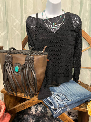 Women's lightweight crochet sweater styled with denim and western accessories