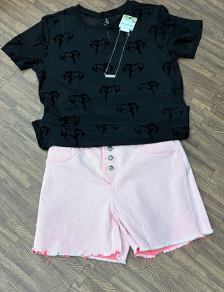 Reversible coral and light pink denim shorts with button-up front, shown styled both ways.