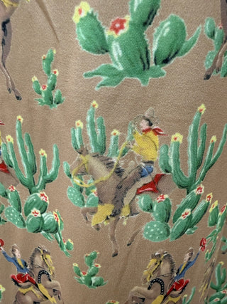 tan western trousers with cactus and close up showing print on retro cowboy print relaxed fit full length pants with pockets boutique outfit