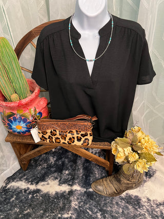Women's lightweight woven blouse with gathered shoulders and relaxed fit