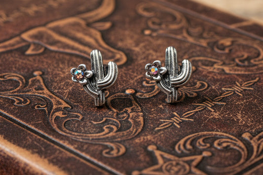Small silver-tone cactus stud earrings with a tiny iridescent rhinestone accent, approximately half an inch in size.