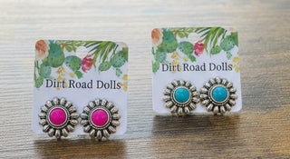 Silver tone flower stud earrings with round faux stone center and detailed petals.