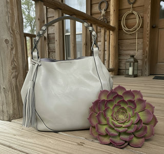 Vegan leather hobo handbag with braided handle and oversized tassel detail