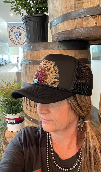 vintage-inspired trucker caps, each featuring feathered designs with a retro western vibe