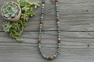 Sterling silver pearl necklace with turquoise and orange and purple spiny oyster beads arranged along a 20-inch strand with mixed bead sizes