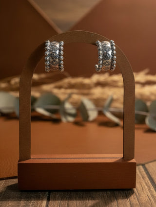 Textured silver tone hoop earrings styled for everyday western fashion.