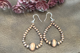     Lightweight copper dangle earrings with graduated bead detail and teardrop shape