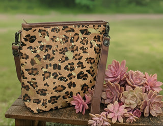 American Darling Portland Bag with cheetah-print hair-on cowhide, gold splatter, leather tassel, concealed carry pocket, and genuine leather construction