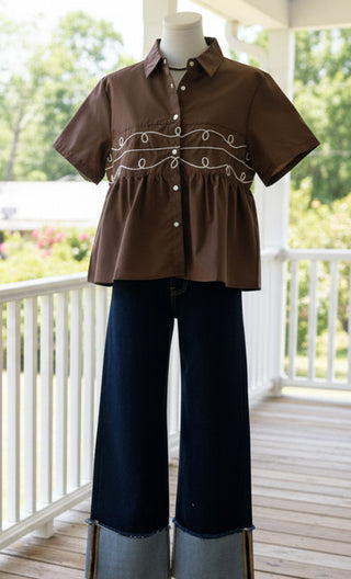 Brown western boutique top for women with button front and relaxed flowy fit styled with dark wash denim
