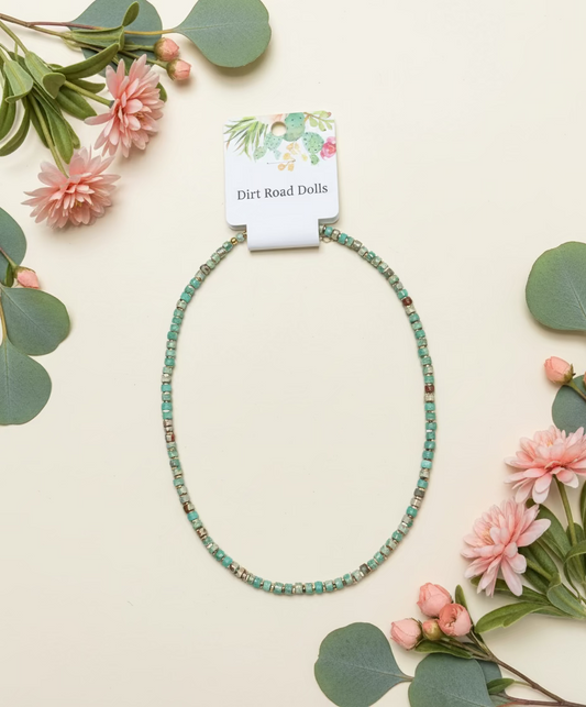 Jade and neutral beaded necklace with gold-tone accents and adjustable length