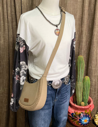 Image of the Alice Floral Top—a white top crafted from soft fabric featuring intricately designed floral sleeves in shades of charcoal and grey.