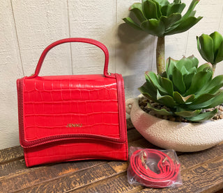 Structured red mini purse featuring crocodile texture and polished top handle styling