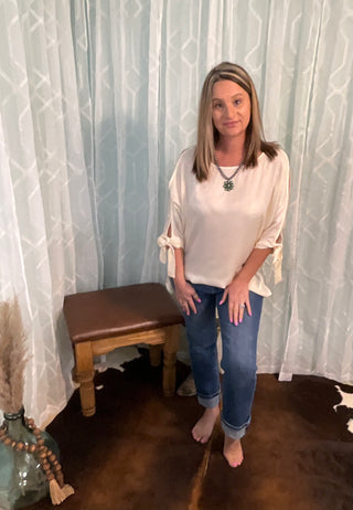 womens bow sleeve blouse with hi lo hem styled with denim casual outfit