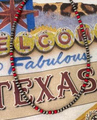 Close up of pearl necklace with red beads statement layering jewelry