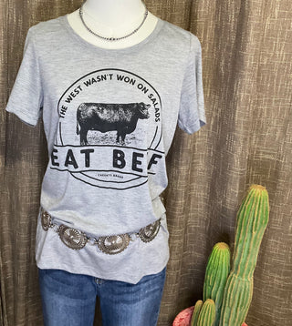 Western lifestyle graphic tee paired with silver concho belt accessories