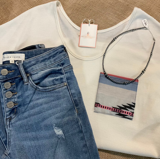 Sasha Top in a cozy waffle knit fabric with a short sleeve silhouette, scoop neckline, and rounded hem. Features an Aztec-inspired chest pocket for a pop of southwestern style. Available in ivory or heather grey.