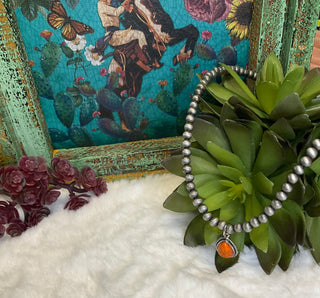 Statement necklace with silver pearl strand and bold teardrop stone pendant