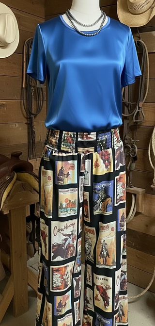 Black palazzo pants with vintage western graphics, featuring a smocked elastic waist. The pants have a wide-leg flowy fit