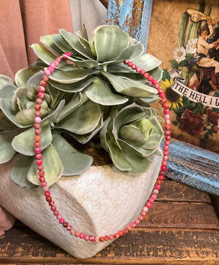 Close up of pink beaded choker necklace bold layering accessory