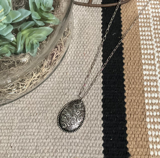 silver paperclip chain necklace with floral tooled teardrop pendant