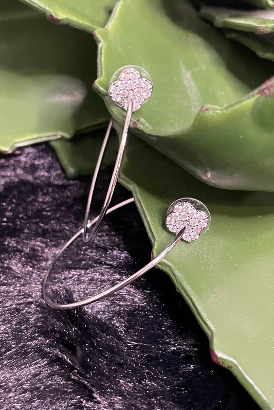 2-inch silver-tone hoop earrings with sparkling pavé clover charm and post-back design.