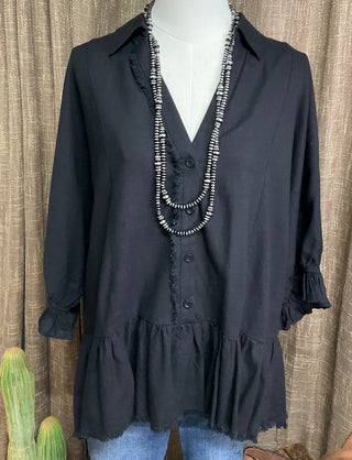Harlie Linen Top in a lightweight, breathable linen fabric featuring a button-up front, 3/4 sleeves, and a ruffled bottom hem with frayed edging for a relaxed yet chic look. Designed for versatile styling across seasons.