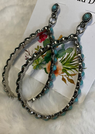 Silver-tone teardrop earrings with ornate detailing and turquoise colored center stones; approx. 2.75" long