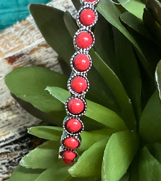 Silver-tone teardrop earrings with ornate detailing and orange colored center stones; approx. 2.75" long