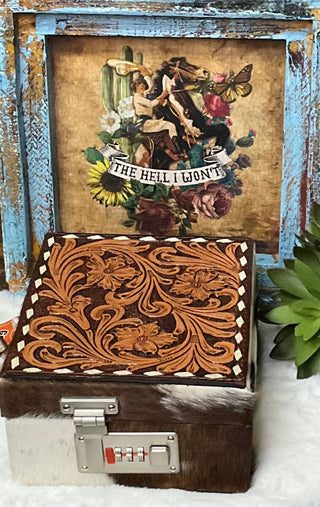 
Hand-tooled leather and hair-on cowhide El Paso Jewelry Case by American Darling with 15 sections, snap closure straps, and a secure locking feature.
