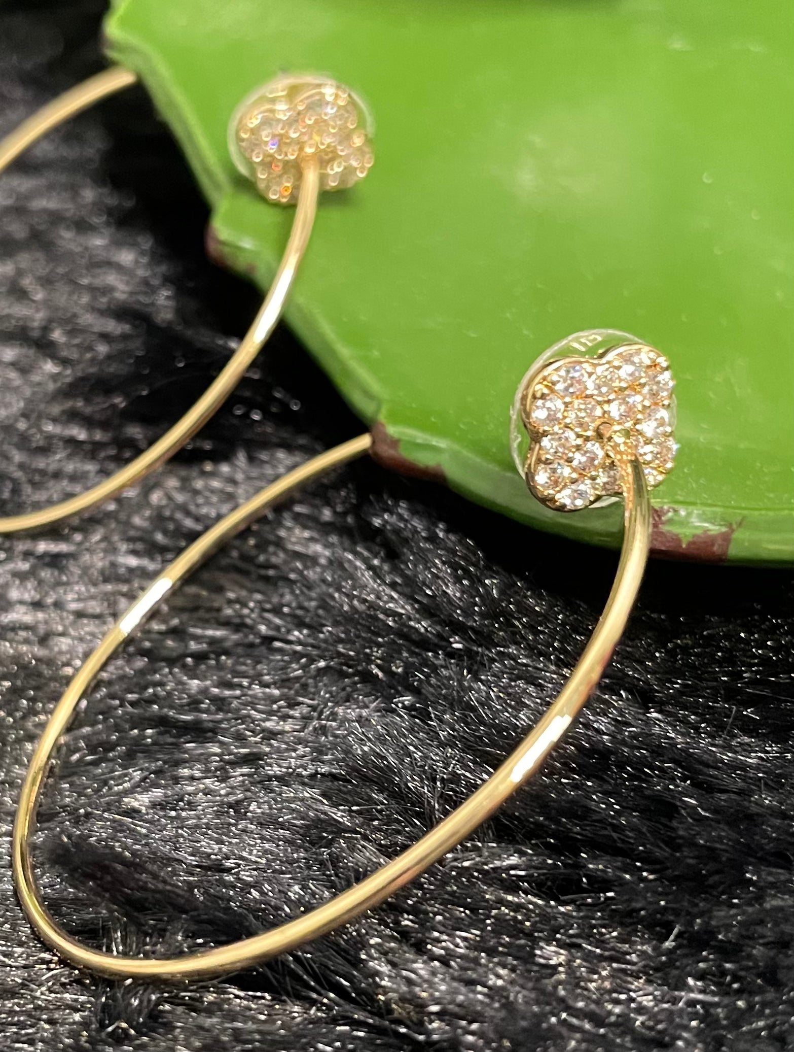 2-inch gold-tone hoop earrings with sparkling pavé clover charm and post-back design.