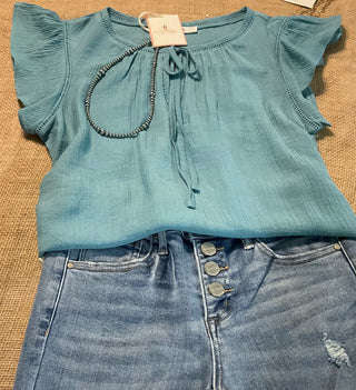 Leslie Ruffle Sleeve Top featuring feminine ruffle sleeves, offering a perfect blend of comfort and style.