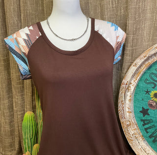 Carmen Aztec Sleeve Top featuring a soft, solid body with vibrant Aztec-patterned sleeves, adding a bold and colorful touch to your look.