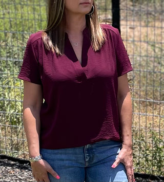 Non-sheer woven blouse with flattering neckline and shoulder detail