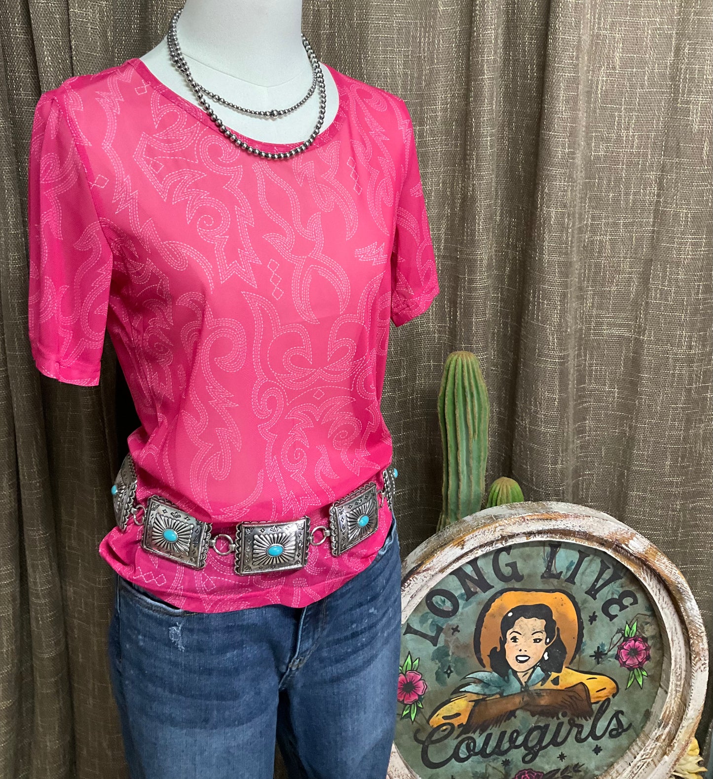 Bri Boot Stitch Mesh Top a hot pink, short-sleeve mesh top featuring an intricate cream boot stitch pattern and a classic round neckline, exuding a chic, western-inspired style.