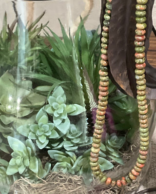 soft colored beaded necklace with green and blush tones layered everyday jewelry