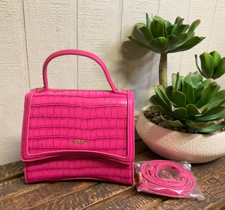 Hot pink crocodile embossed mini handbag with gold hardware and crossbody strap