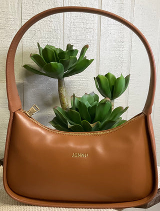 Structured vegan leather shoulder bag with gold hardware and minimalist silhouette