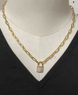 gold chain necklace with lock charm styled with v neck outfit