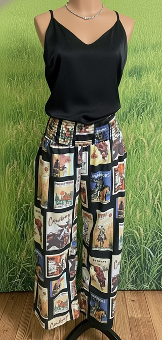 Black palazzo pants with vintage western graphics, featuring a smocked elastic waist. The pants have a wide-leg flowy fit
