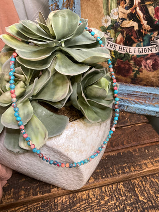Close up of pink and turquoise beaded choker necklace bold layering accessory
