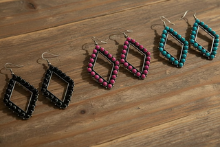 Open diamond-shaped earrings lined with round beads available in burnished silver tone, pink, or turquoise on a silver-tone frame with French hooks.