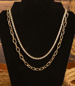 Gold layered necklace set featuring rhinestone strand and paperclip chain