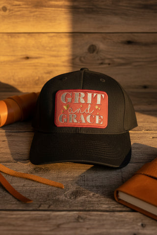 Black Grit & Grace snapback baseball cap with embroidered front patch.