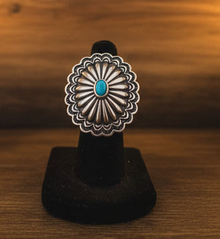 Silver tone adjustable concho ring with faux turquoise center stone.