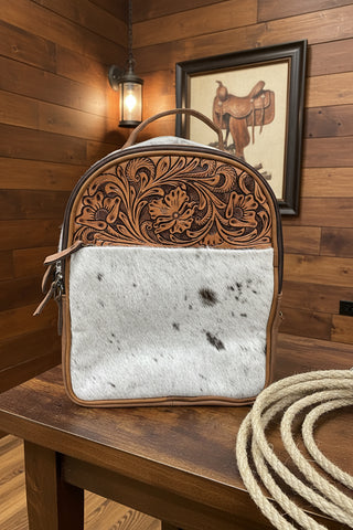 Genuine cowhide backpack featuring hand-tooled floral leather and western styling