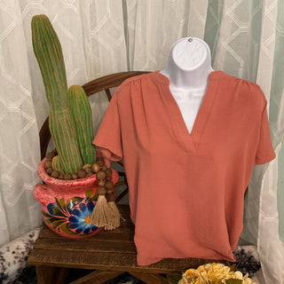 Non-sheer woven blouse with flattering neckline and shoulder detail