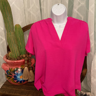 Women's lightweight woven blouse with gathered shoulders and relaxed fit