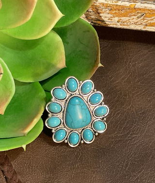 Women's Western turquoise ring with adjustable band and silver-tone floral cluster design.