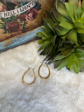 Faux gold elongated hoop earrings, approx. 1.5 inches long, lightweight modern design